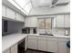 Bright kitchen features white cabinets, modern appliances, and a window above the sink at 600 N Boundary Ave # 115D, Deland, FL 32720