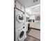 Efficient white kitchen with modern washer-dryer combo and lots of natural light at 600 N Boundary Ave # 115D, Deland, FL 32720