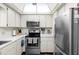 Kitchen features white cabinets, modern appliances, and ample counter space at 600 N Boundary Ave # 115D, Deland, FL 32720