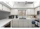 Bright kitchen features white cabinets, modern appliances, and a window above the sink at 600 N Boundary Ave # 115D, Deland, FL 32720