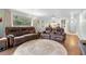 Living room boasts hardwood floors, a large window, and comfortable seating at 600 N Boundary Ave # 115D, Deland, FL 32720