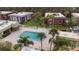 Aerial view of condo complex featuring a pool, palm trees, and well-maintained grounds at 600 N Boundary Ave # 115D, Deland, FL 32720