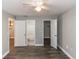 Bedroom featuring wood floors and entryways to a bathroom and two walk-in closets at 623 Dory Ln # 209, Altamonte Springs, FL 32714