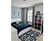 This themed bedroom features a playful game rug, gray curtains, and gaming decor at 7024 Lanier Falls Rd, Deland, FL 32724