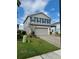 Two-story home with gray siding, blue shutters, and a brick driveway at 7024 Lanier Falls Rd, Deland, FL 32724