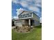 Two-story home with gray siding, blue shutters, and a well manicured front lawn at 7024 Lanier Falls Rd, Deland, FL 32724
