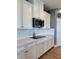 The kitchen features white cabinets, modern appliances, and a sleek cooktop at 7024 Lanier Falls Rd, Deland, FL 32724
