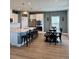 Spacious kitchen with an island, bar seating and stainless steel appliances next to the dining area at 7024 Lanier Falls Rd, Deland, FL 32724