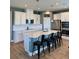 Modern kitchen featuring white cabinets, an island with seating, and stainless steel appliances at 7024 Lanier Falls Rd, Deland, FL 32724