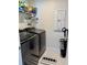 A functional laundry room with modern washer, dryer, shelving, and neutral decor at 7024 Lanier Falls Rd, Deland, FL 32724
