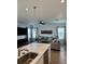 Bright living room with wood floors and an open layout, adjacent to the kitchen at 7024 Lanier Falls Rd, Deland, FL 32724