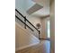 Beautiful staircase with dark wooden rails and white walls, showcasing modern design at 7024 Lanier Falls Rd, Deland, FL 32724