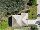 Aerial view showcasing the home's unique roof design and well-manicured landscaping at 72 Aurora Ave, Ponce Inlet, FL 32127