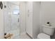 Bathroom with white marble tiled shower and toilet at 72 Aurora Ave, Ponce Inlet, FL 32127