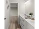 Bathroom with a double vanity sink and an entrance to another room at 72 Aurora Ave, Ponce Inlet, FL 32127