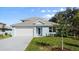 Charming single-story home with a well-manicured lawn, neutral paint, and an attached two-car garage at 72 Aurora Ave, Ponce Inlet, FL 32127