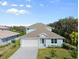 Charming single-Gathering home with two car garage, lush lawn, and beautiful Florida foliage at 72 Aurora Ave, Ponce Inlet, FL 32127