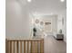Hallway with bright wood floors, a view of the stairwell, and modern decorations at 72 Aurora Ave, Ponce Inlet, FL 32127