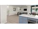 Modern kitchen view leading to living room, with light wood floors at 72 Aurora Ave, Ponce Inlet, FL 32127