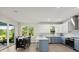 Kitchen with island and eat-in table, stainless appliances and bright lighting at 72 Aurora Ave, Ponce Inlet, FL 32127