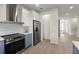 Updated kitchen features stainless steel appliances, backsplash and wood floors at 72 Aurora Ave, Ponce Inlet, FL 32127