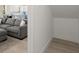 Open-concept living room with hardwood floors, a gray sectional sofa, and a glimpse of the kitchen at 72 Aurora Ave, Ponce Inlet, FL 32127