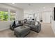 Comfortable living room with neutral tones, large sectional and view to kitchen at 72 Aurora Ave, Ponce Inlet, FL 32127
