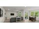 Spacious living room with a cozy seating area, a dining table, and sliding doors leading to the outdoors at 72 Aurora Ave, Ponce Inlet, FL 32127
