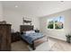 Cozy primary bedroom with natural light, wood floors and modern furniture at 72 Aurora Ave, Ponce Inlet, FL 32127
