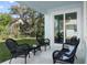Relaxing covered patio features stylish wicker furniture, seamlessly connecting indoor and outdoor living spaces at 72 Aurora Ave, Ponce Inlet, FL 32127