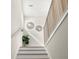 Staircase featuring decorative wall decor, wood railing, and hardwood steps at 72 Aurora Ave, Ponce Inlet, FL 32127