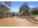 Enjoy the backyard deck with views of the pond and mature trees, perfect for outdoor relaxation and entertaining at 725 E New York Ave, Orange City, FL 32763