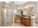 Bright bathroom featuring a glass-enclosed shower, large vanity, and ample lighting for a refreshing experience at 725 E New York Ave, Orange City, FL 32763