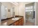 Bright bathroom featuring a shower over tub and large mirror at 725 E New York Ave, Orange City, FL 32763