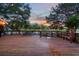 Serene view of a wooden deck with outdoor seating overlooking a peaceful lake at twilight at 725 E New York Ave, Orange City, FL 32763