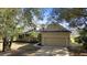 Attractive home exterior with a well-manicured lawn, two-car garage, and inviting front porch at 725 E New York Ave, Orange City, FL 32763