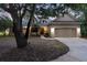 Inviting two-story home with a cozy front porch and a well-kept lawn at 725 E New York Ave, Orange City, FL 32763