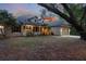 Charming two-story home with a welcoming front porch and well-maintained landscaping at 725 E New York Ave, Orange City, FL 32763