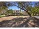 Charming home with a well-maintained front yard, lush trees, and outdoor bar nearby at 725 E New York Ave, Orange City, FL 32763