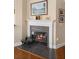 Elegant fireplace with decorative mantel and black tile, with glass doors showcasing the fire within at 725 E New York Ave, Orange City, FL 32763