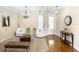 Inviting foyer area with decorative front door, modern chandelier and stylish furniture at 725 E New York Ave, Orange City, FL 32763