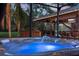 Relaxing hot tub with seating and a view of an outdoor kitchen and bar area at 725 E New York Ave, Orange City, FL 32763