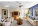 Bright living room with hardwood floors, modern furniture, and large windows that fill the space with natural light at 725 E New York Ave, Orange City, FL 32763