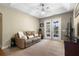 Relaxing living room with a leather sofa, television, and a view of the outdoor deck through French doors at 725 E New York Ave, Orange City, FL 32763