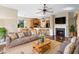 Open living room with a cozy fireplace, barstool seating and an adjacent dining area at 725 E New York Ave, Orange City, FL 32763