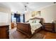 Inviting main bedroom featuring an elegant bed, ceiling fan, and a sunny bay window at 725 E New York Ave, Orange City, FL 32763