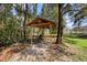 Charming outdoor bar area nestled amongst the trees, perfect for relaxing and enjoying refreshments at 725 E New York Ave, Orange City, FL 32763