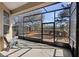 Screened patio area with a view of a wooden deck and a scenic body of water at 725 E New York Ave, Orange City, FL 32763