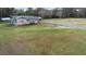 Aerial shot of the house with brick facade, detached garage, shed, and long driveway at 753 Glenwood Rd, Deland, FL 32720