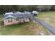 Drone view of the home, garage, and storage shed with a long paved driveway, and large yard at 753 Glenwood Rd, Deland, FL 32720